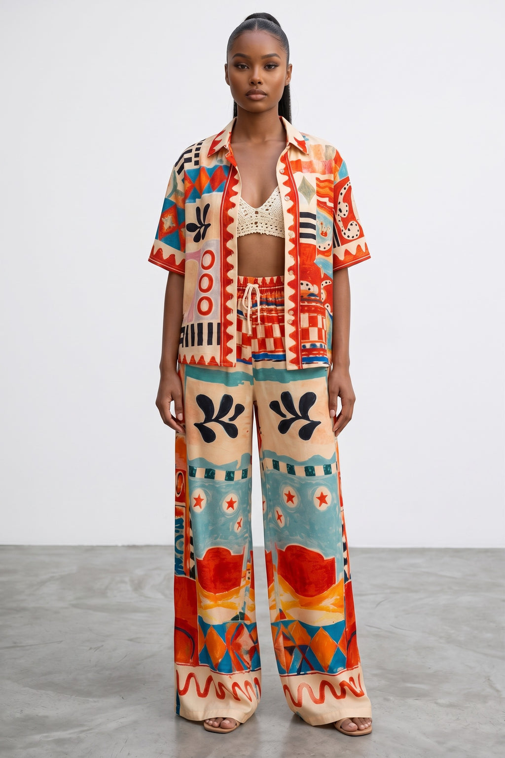 Model wearing Hush Boutique Art of Vacation two-piece set with abstract print in red, turquoise, orange, and cream.