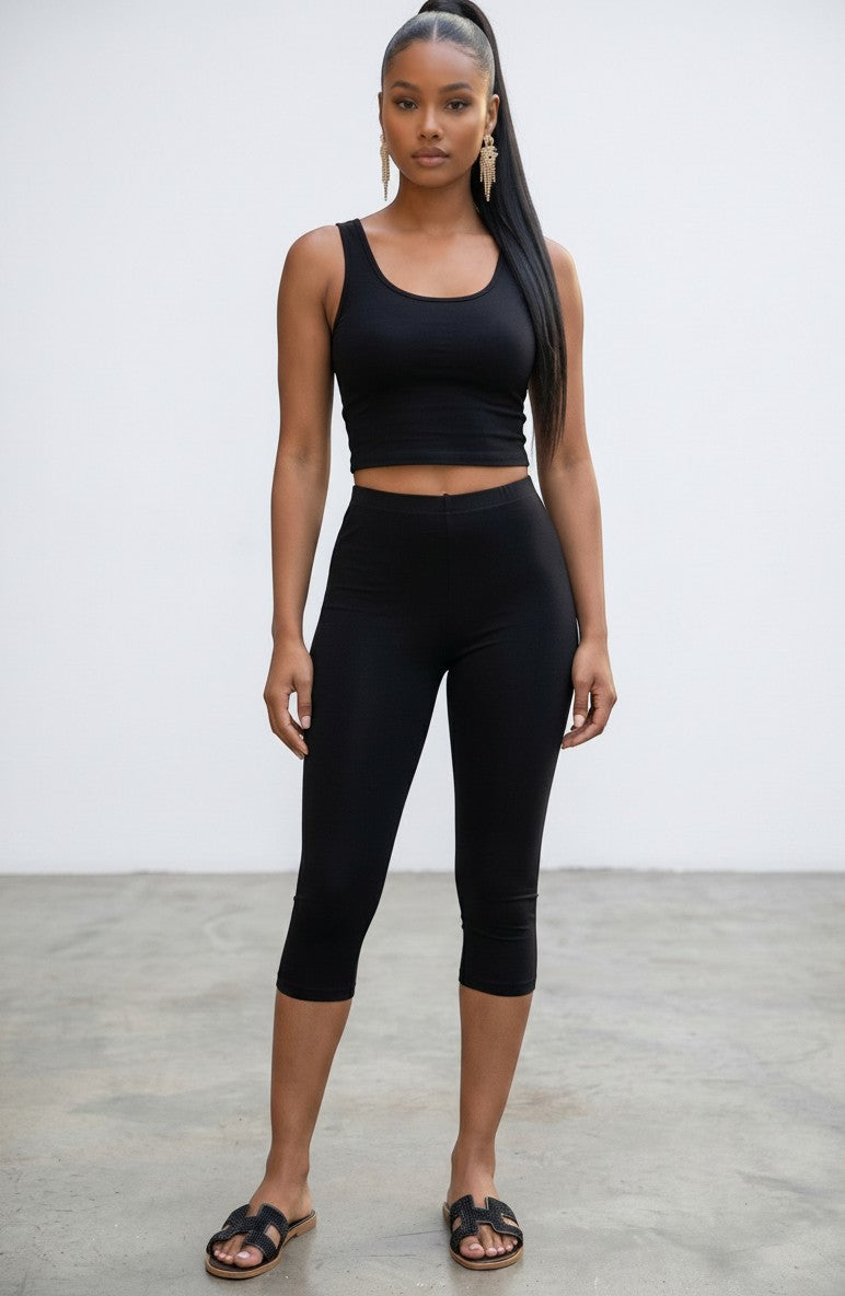 Model wearing Hush Boutique black cotton capri leggings and matching tank top with sandals against a white background
