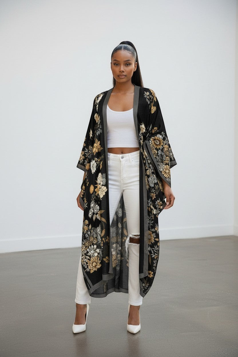 Model wearing a Hush Boutique black floral kimono over a white tank top and distressed white jeans