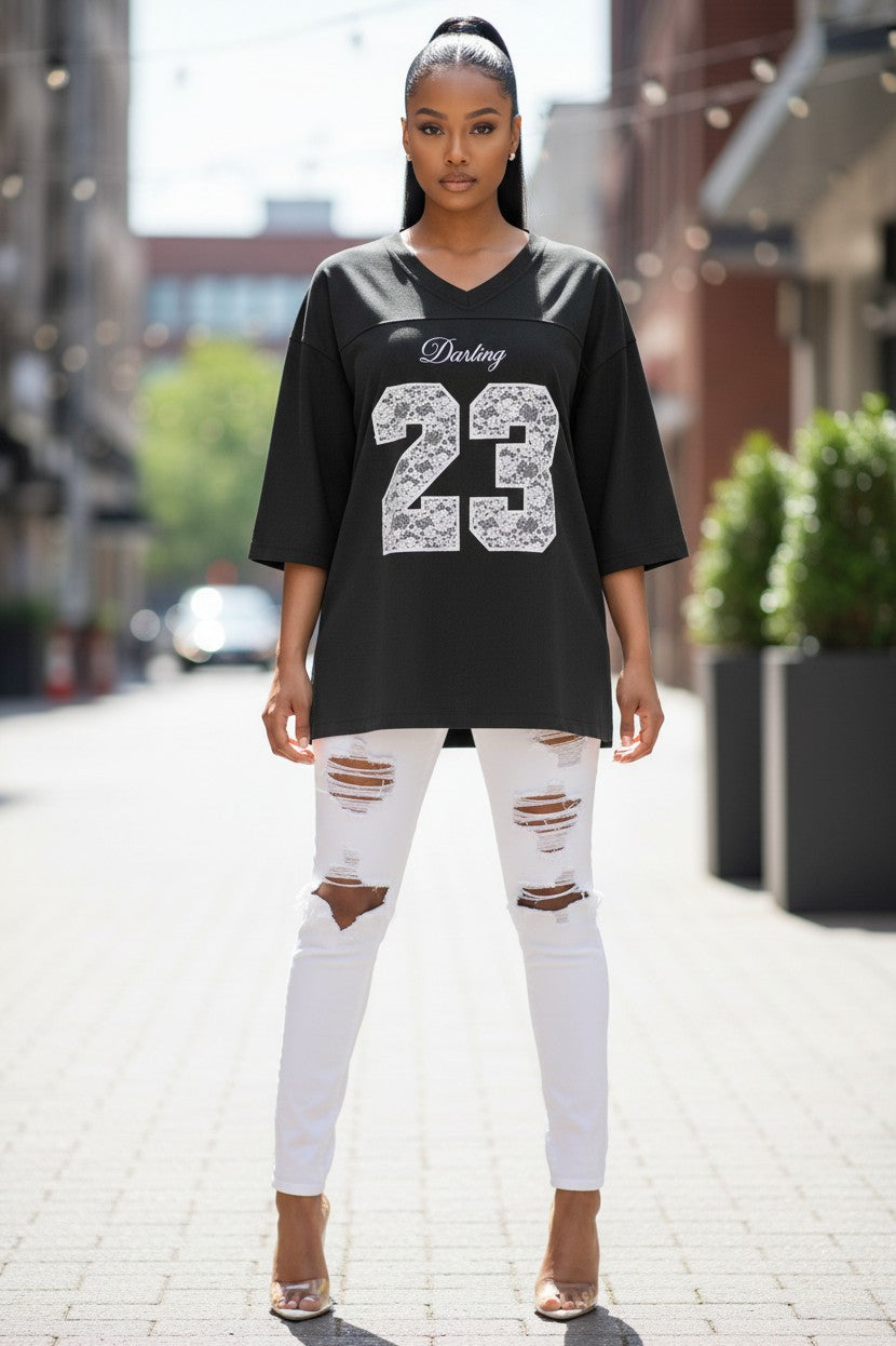 Hush Boutique black heavy cotton jersey v-neck t-shirt with white lace embroidered "Darling 23" graphic.