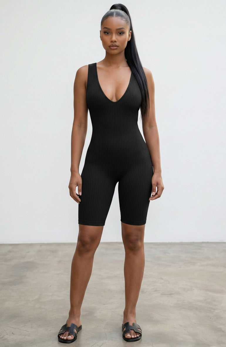 Hush Boutique black ribbed seamless sleeveless romper with a deep V-neckline worn by a model.