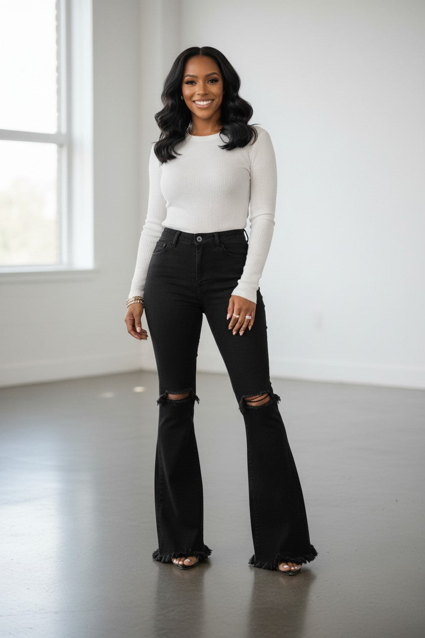 Hush Boutique Azalea black high-waisted flare jeans with ripped knees and frayed hem. Cotton-spandex blend.