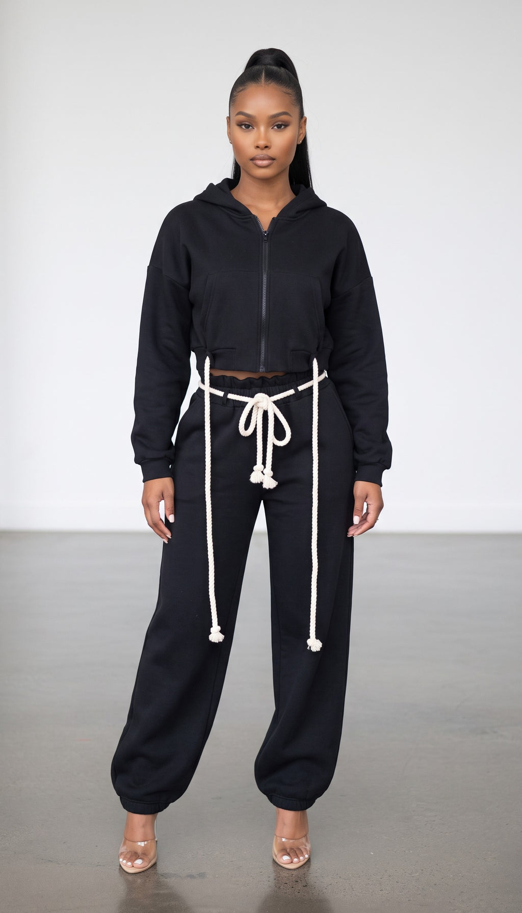 Hush Boutique black two-piece set featuring a cropped zip-up hoodie and wide-leg sweatpants with rope waist ties.