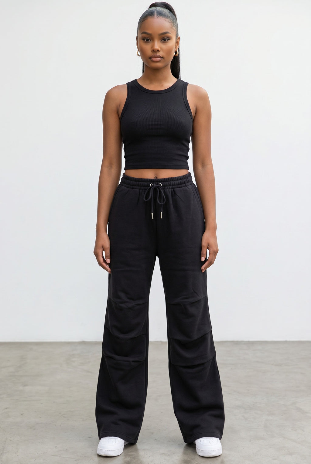 Model wearing Hush Boutique black wide leg fleece sweatpants with an elastic drawstring waist and relaxed fit.