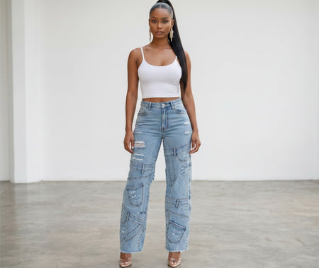 Model wearing Hush Boutique light wash denim cargo jeans with distressed details and invisible pockets