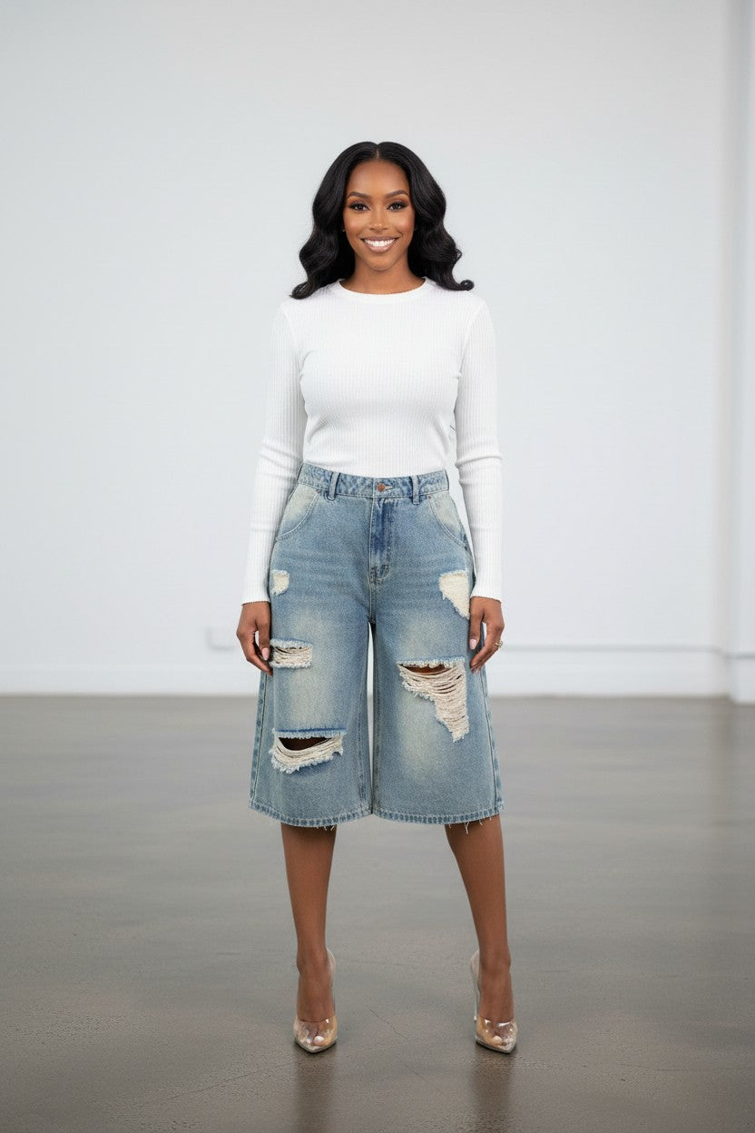 Hush Boutique light wash distressed denim jorts with multiple pockets and a loose fit, knee-length.