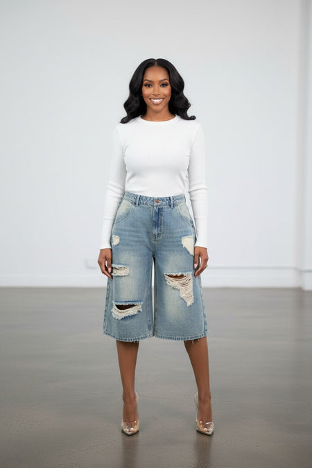 Hush Boutique light wash distressed denim jorts with multiple pockets and a loose fit, knee-length.