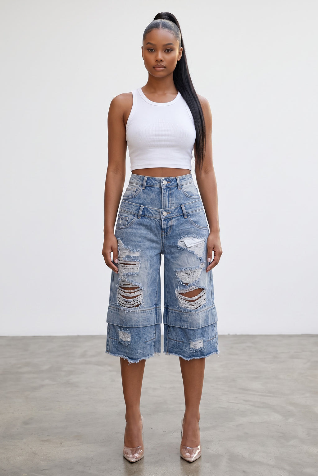 Model wearing Hush Boutique vintage light wash denim jorts with double-waisted design and distressed ripped details.