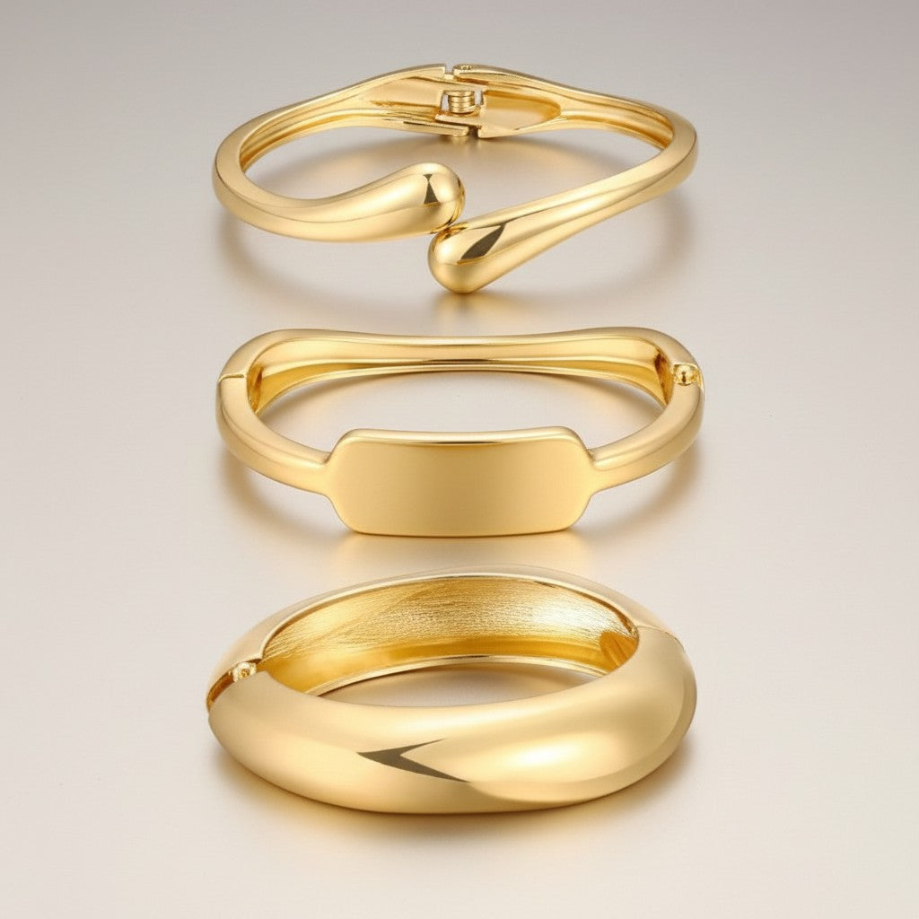 Hush Boutique set of 3 gold-tone metal bracelets with abstract, modern designs. Includes cuff and bangle styles.