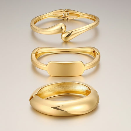 Hush Boutique set of 3 gold-tone metal bracelets with abstract, modern designs. Includes cuff and bangle styles.