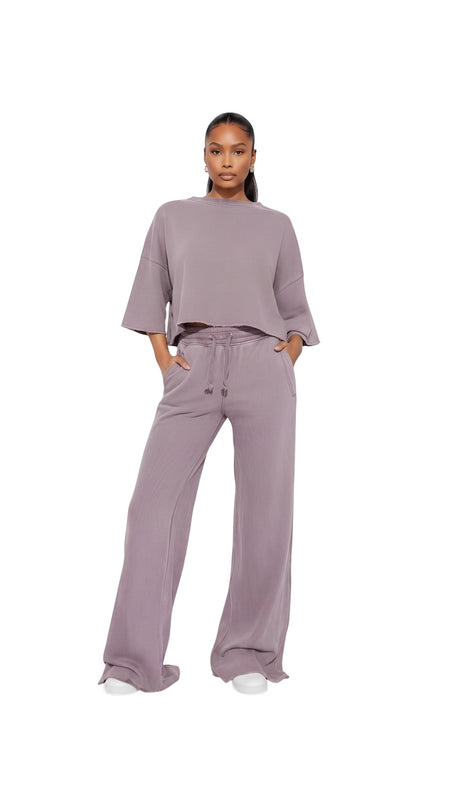 Hush Boutique vintage garment dyed mauve two-piece set with a cropped boxy top and wide-leg elastic waist pants.