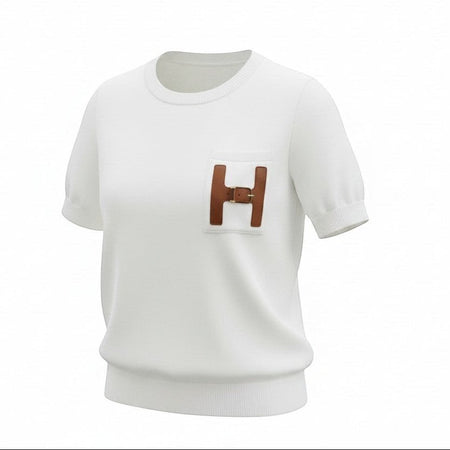 Hush Boutique off-white crew-neck t-shirt in viscose-nylon blend with a decorative H-shaped pocket trimmed in faux leather and a gold buckle.