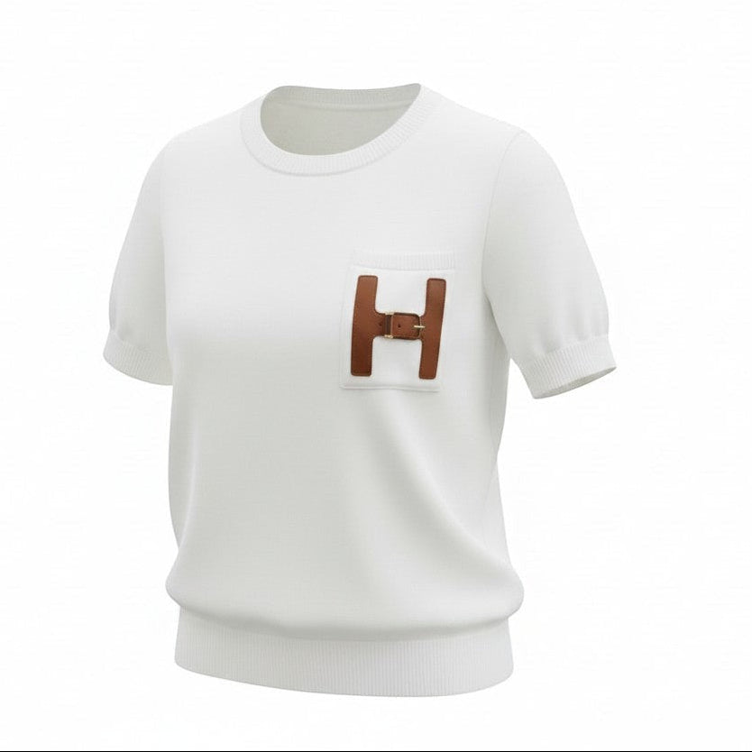Hush Boutique off-white crew-neck t-shirt in viscose-nylon blend with a decorative H-shaped pocket trimmed in faux leather and a gold buckle.