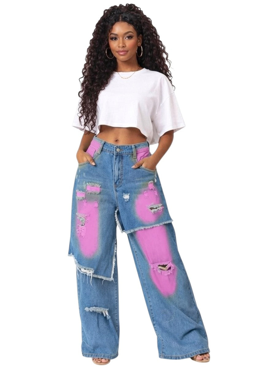 Hush Boutique blue denim wide-leg jeans with yellow paint splatters and distressed details.