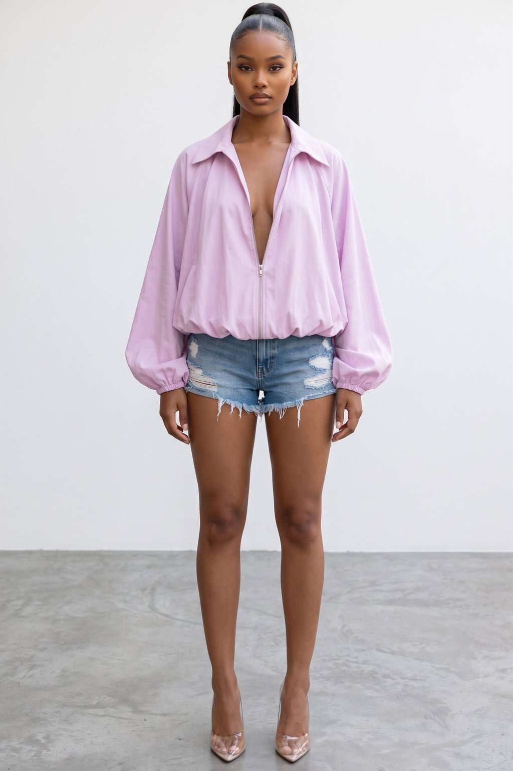 Model wearing a Hush Boutique oversized light pink balloon-style zip-up jacket with dramatic sleeves and gathered hem.