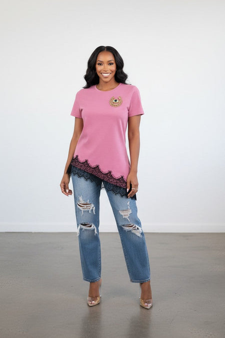 Hush Boutique pink cotton t-shirt with crew neck, short sleeves, eye motif, and black lace trim on asymmetrical hem.