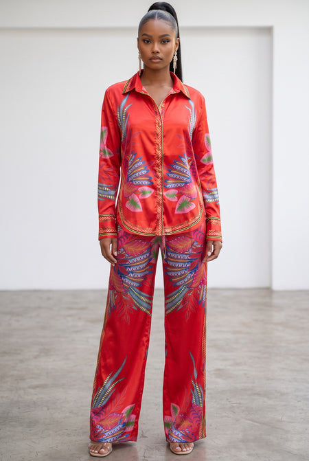 Hush Boutique red satin two-piece pants set with a vibrant floral print, button-down shirt, and wide-leg trousers.