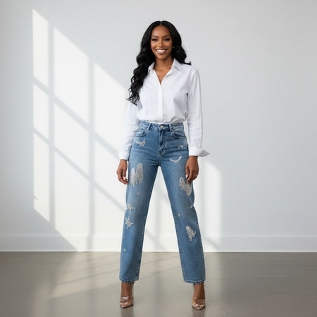 Hush Boutique vintage-wash blue denim jeans with scattered rhinestone and brooch embellishments in celestial and abstract shapes.