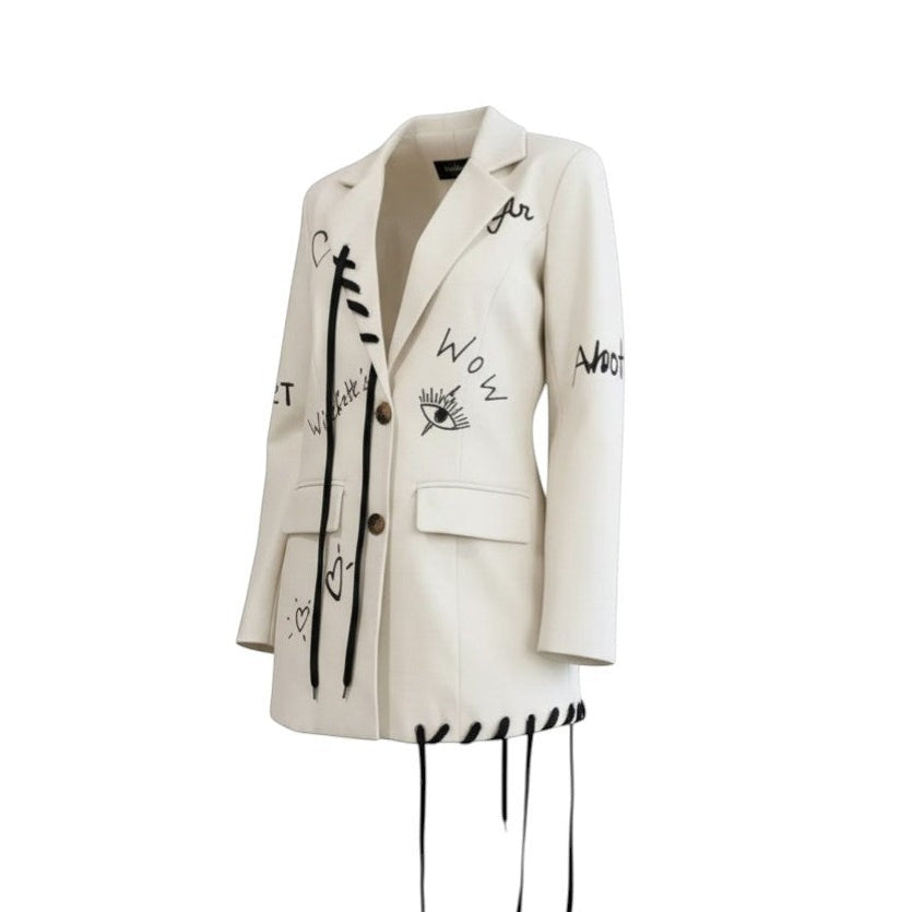 Hush Boutique cream blazer dress with black graphic print and rope detailing. Features lapel collar, button closure, and lace-up hem.