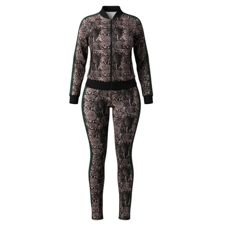 Hush Boutique women's two-piece tracksuit with a snake print pattern, black collar, and green side stripes. Features a zip-up jacket and split-hem pants.