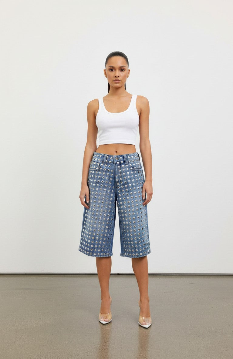 Model wearing Hush Boutique PrimRose denim Bermuda shorts featuring all-over silver metal stud embellishments.