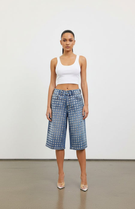 Model wearing Hush Boutique PrimRose denim Bermuda shorts featuring all-over silver metal stud embellishments.